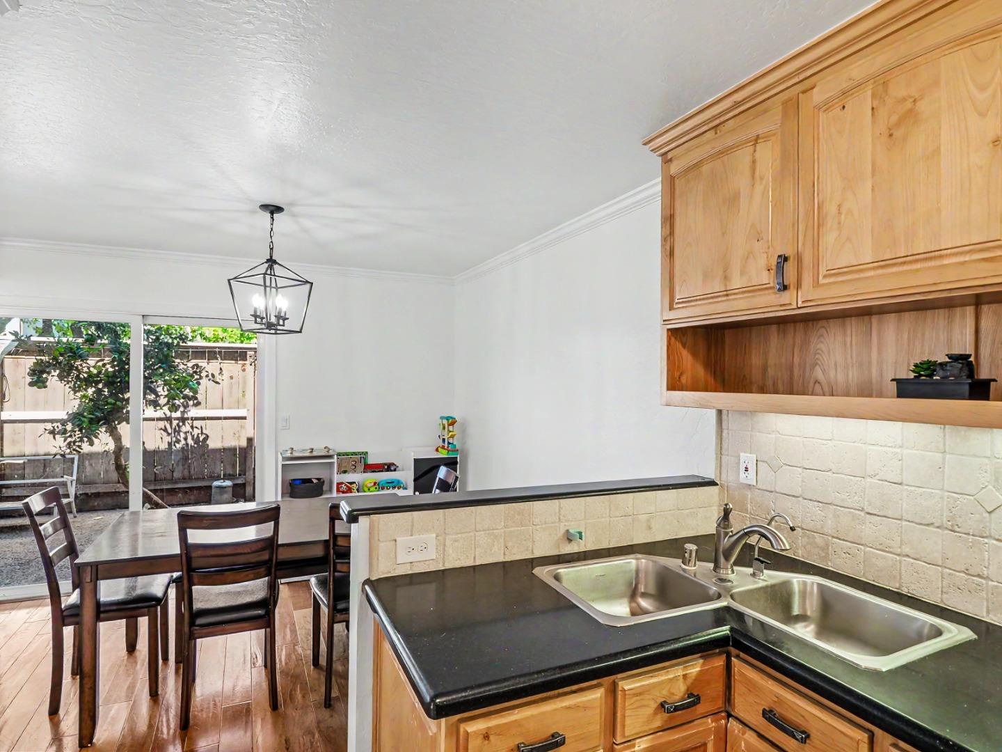1310 Primavera Street, Unit 109 Salinas, CA 93901 - Photo 7 of 37 a kitchen that has a sink and a table with chairs