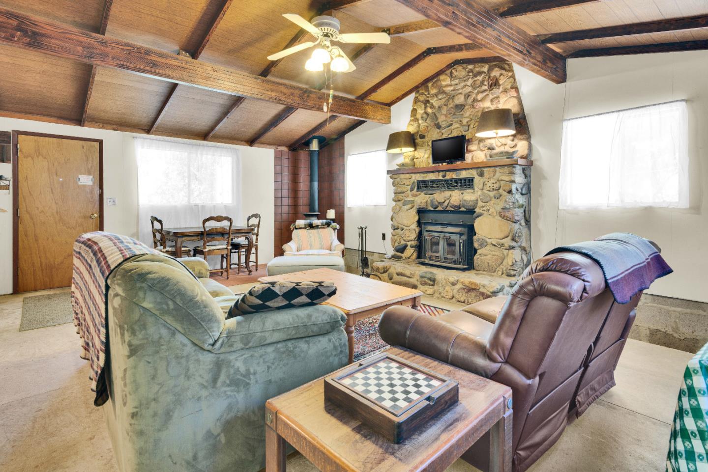47527 Arroyo Seco Road, Unit 41 Greenfield, CA 93927 - Photo 13 of 22 a living room with furniture a fireplace and a table