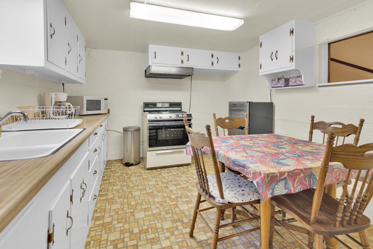 47527 Arroyo Seco Road, Unit 41 Greenfield, CA 93927 - Photo 16 of 22 a kitchen with stainless steel appliances granite countertop a sink a stove a table and chairs