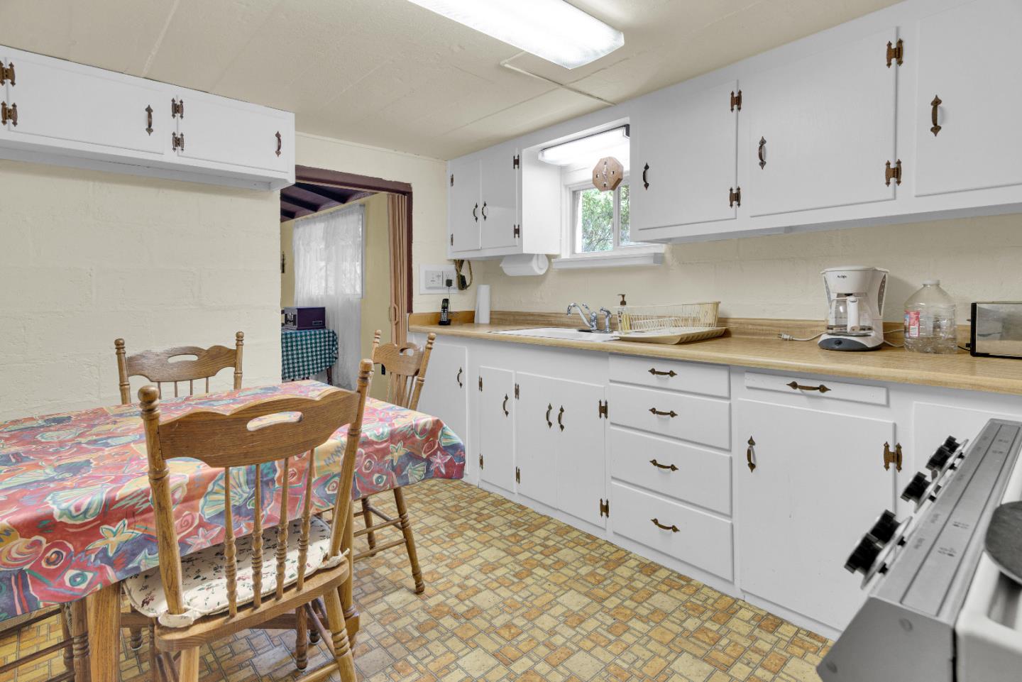 47527 Arroyo Seco Road, Unit 41 Greenfield, CA 93927 - Photo 17 of 22 a kitchen with stainless steel appliances granite countertop a sink a stove a dining table and chairs