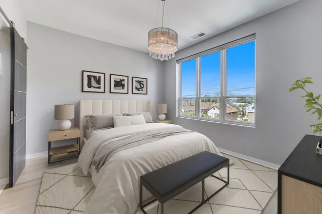 a spacious bedroom with a bed and a window