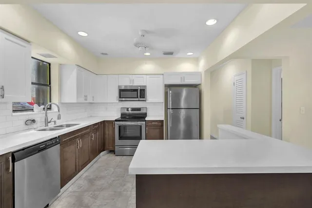 a kitchen with a sink stove and microwave