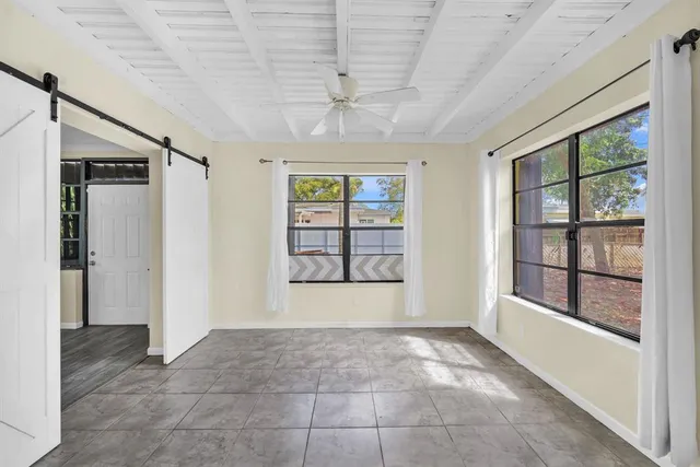 an empty room with windows and closet