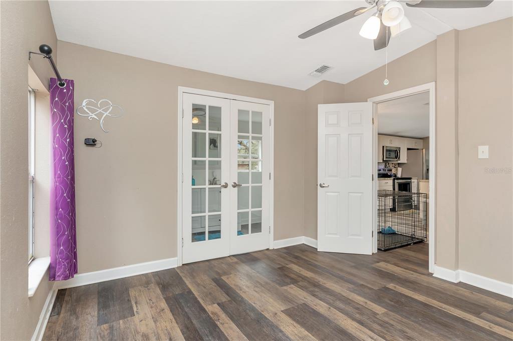 16323 Alliance Lane Spring Hill, FL 34610 - Photo 13 of 34 an empty room with wooden floor closet and windows