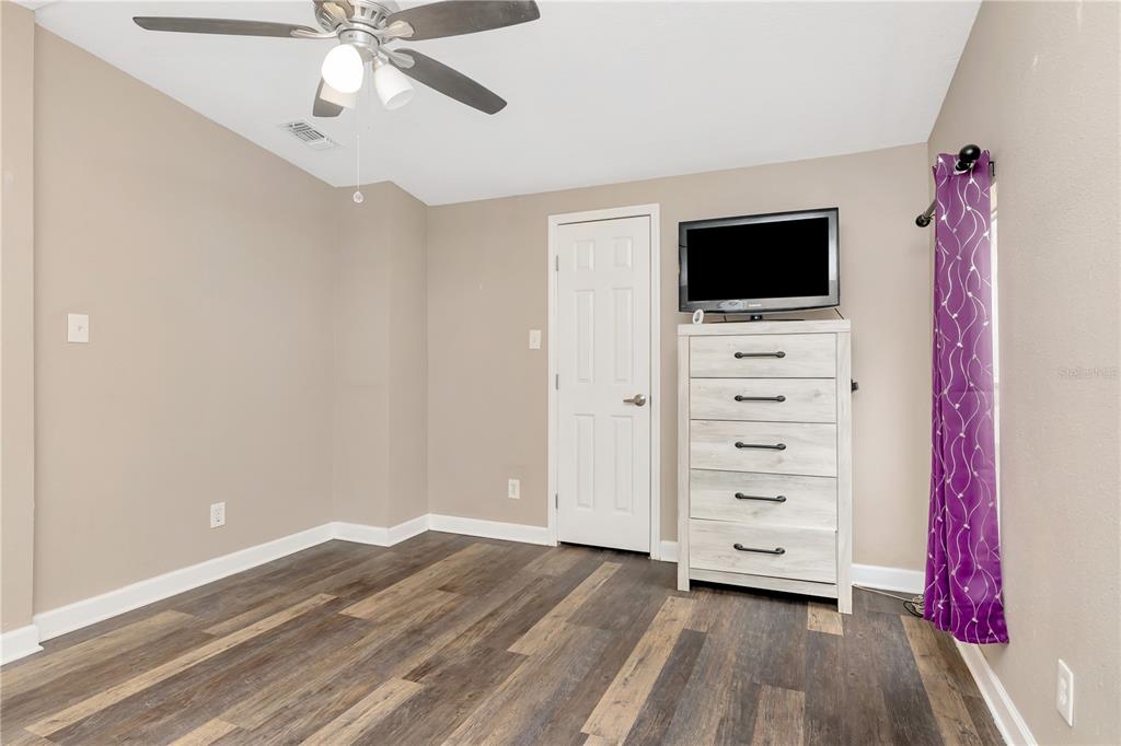 16323 Alliance Lane Spring Hill, FL 34610 - Photo 14 of 34 a view of room with wooden floor and flat screen tv