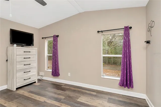 a view of room with window and flat screen tv