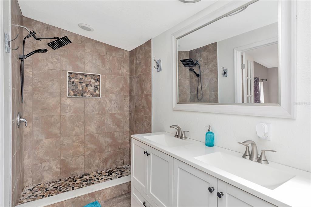 16323 Alliance Lane Spring Hill, FL 34610 - Photo 16 of 34 a bathroom with a sink and a mirror