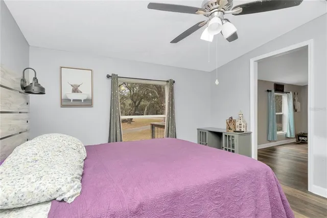 a bedroom with a large bed and a chandelier