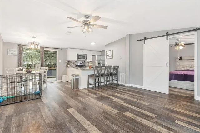 a living room with furniture and view of kitchen
