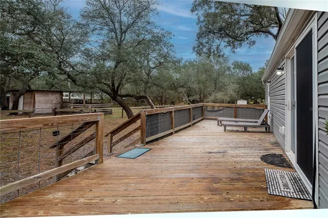 a backyard of a house with oven and wooden fence