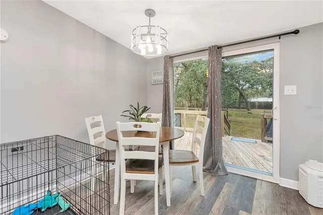 a dining room with furniture and wooden floor