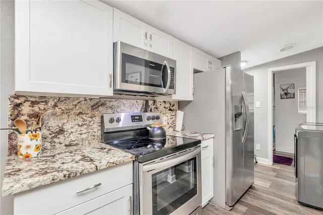 a stove top oven sitting inside of a kitchen