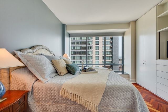 a bedroom with a bed and a large window