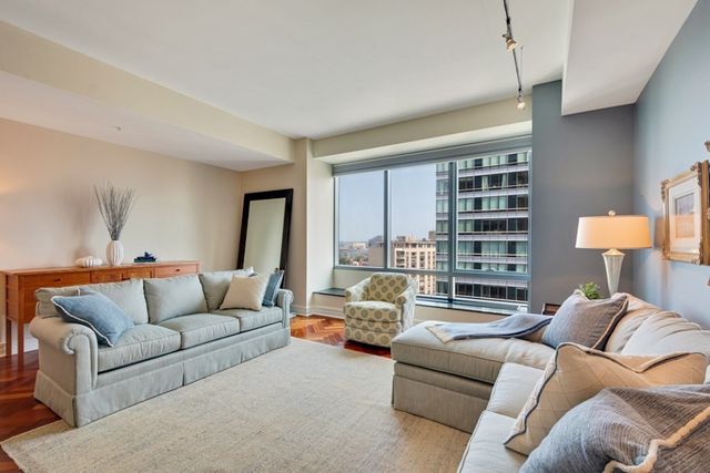 a living room with furniture and a large window