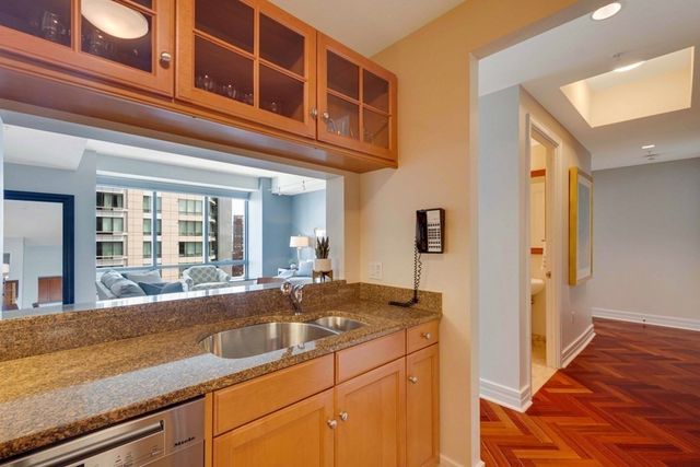 a view of a kitchen with a sink and cabinets