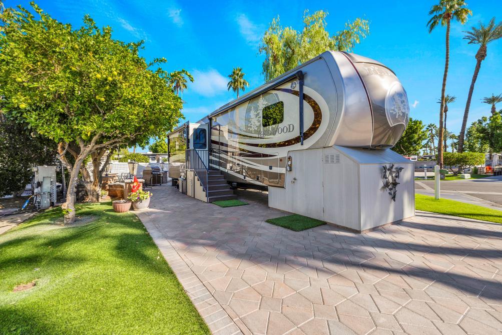 a front view of a house with garden and sitting area