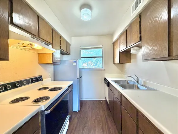 a kitchen that has a sink and a stove
