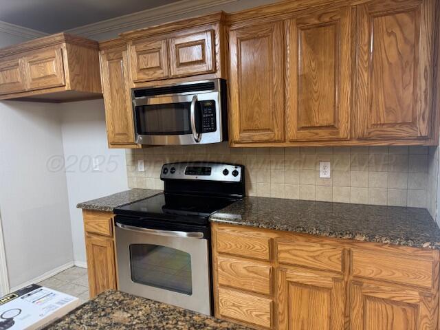 4525 Ida Louise Court Amarillo, TX 79110 - Photo 6 of 14 a kitchen with stainless steel appliances granite countertop a stove a microwave and cabinets