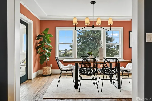 a view of a dining room with furniture window and wooden floor