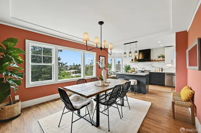 a view of a dining room with furniture window and wooden floor