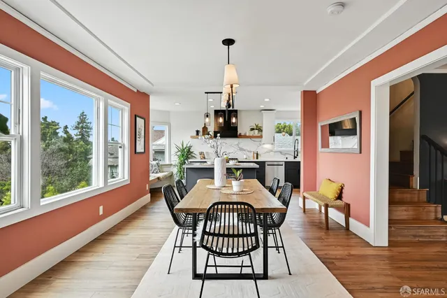 a dining room with furniture a chandelier and wooden floor
