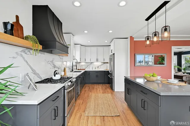 a kitchen with stainless steel appliances granite countertop a sink and cabinets