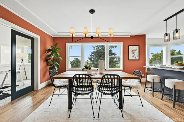 a view of a dining room with furniture window and wooden floor