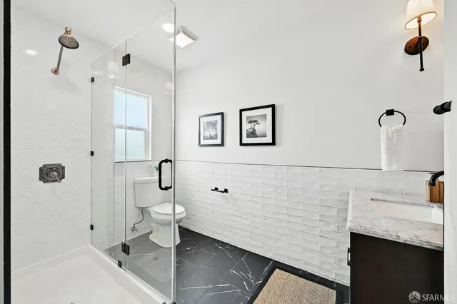 a bathroom with a toilet and a shower