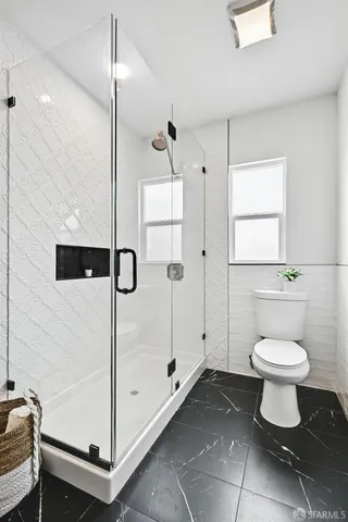 a bedroom with bed and a night stand