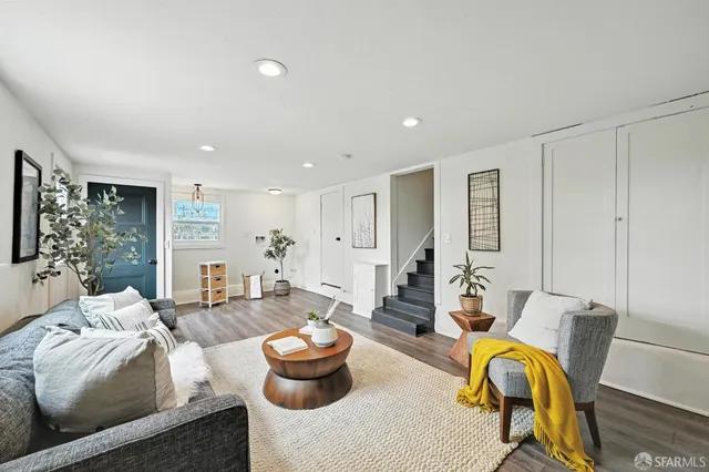 a living room with furniture and a potted plant