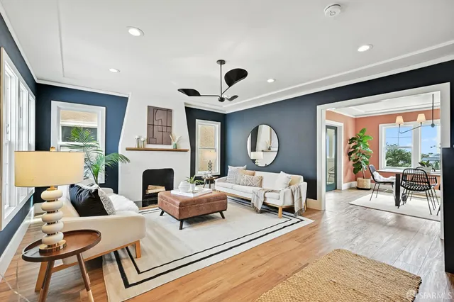 a living room with fireplace furniture and a large window