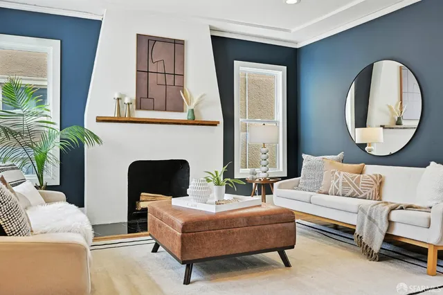 a living room with furniture fireplace and a large mirror