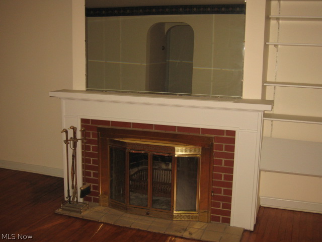 1141 Middlebury Road Kent, OH 44240 - Photo 5 of 25 WOOD BURNING FIREPLACE WITH BRICK SURROUND, MANTLE AND MIRROR. ARCHWAY ENTRY IS TO BEDRM WING