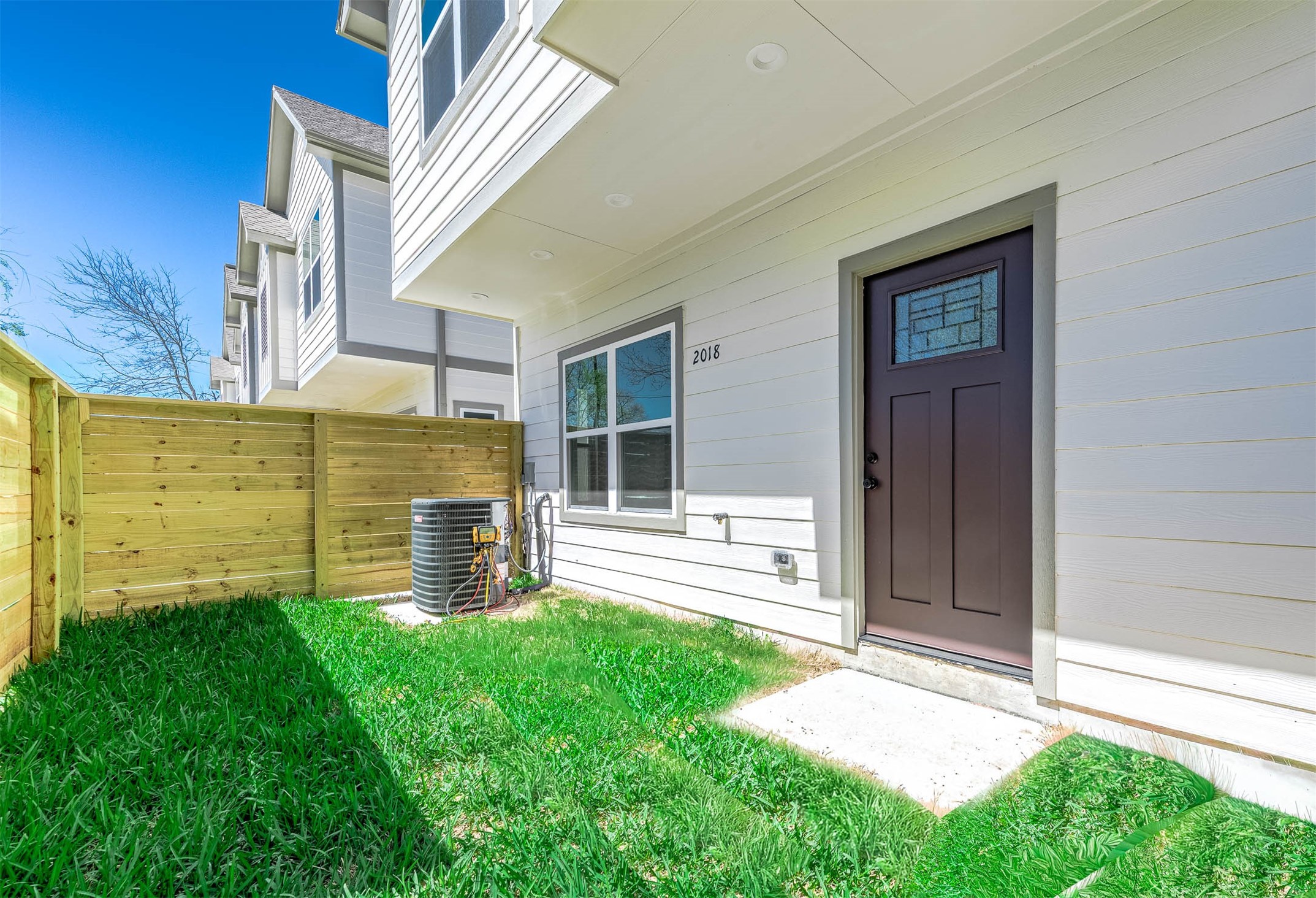 2018 Hampton Street, Unit A B Houston, TX 77088 - Photo 27 of 31 Unit A's mirror-image yard — same footprint, separate access, no shared space. (Image edited to show expected spring grass growth.)