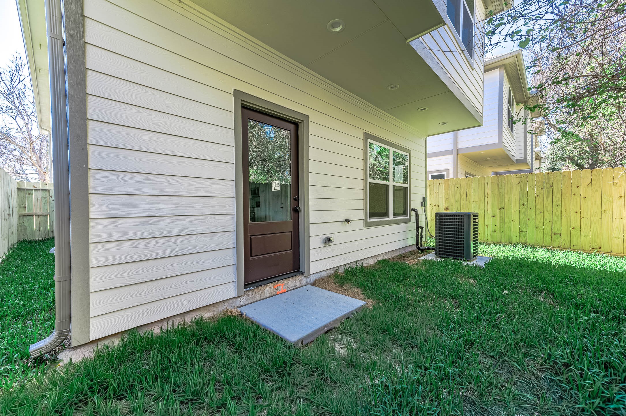 2018 Hampton Street, Unit A B Houston, TX 77088 - Photo 28 of 31 Unit B's outdoor footprint — fenced, private, and ready for a patio set or pet run. (Image edited to show expected spring grass growth.)