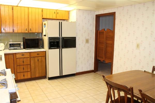 524 Marrett Road Lexington, MA 02421 - Photo 8 of 15 a kitchen with stainless steel appliances a stove a refrigerator a sink a dining table and chairs