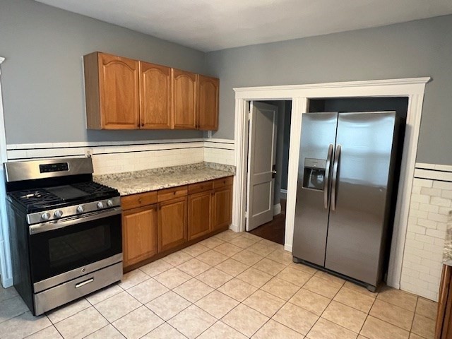 146 Homestead Street Boston, MA 02121 - Photo 1 of 3 a kitchen with a refrigerator stove and cabinets
