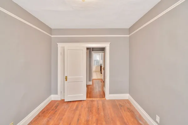 a view of room with window and hardwood floor