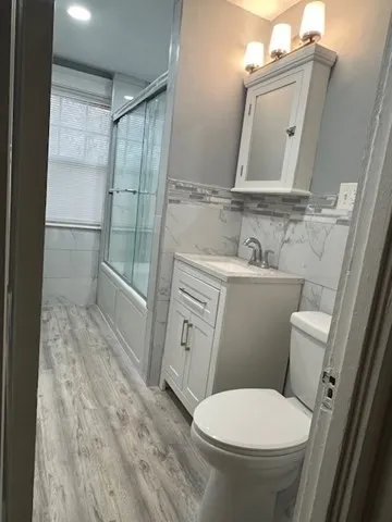 a bathroom with a toilet a sink and a mirror