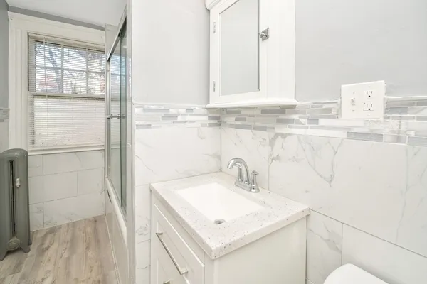 a bedroom with furniture window and wooden floor