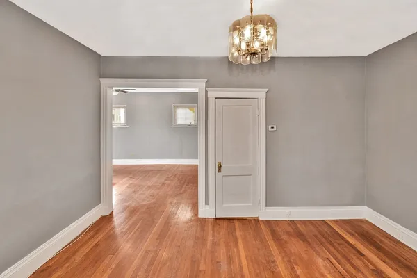a living room with a cabinet and a large window