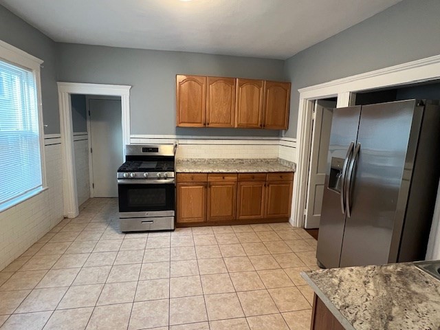 146 Homestead Street Boston, MA 02121 - Photo 3 of 3 a kitchen with stainless steel appliances granite countertop a refrigerator a stove and a sink