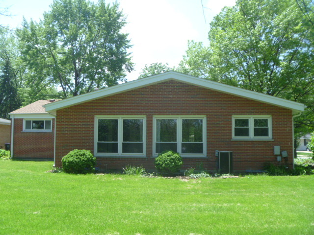 1513 North Ridge Avenue Arlington Heights, IL 60004 - Photo 13 of 14 a house that is sitting in front of a big yard with large trees