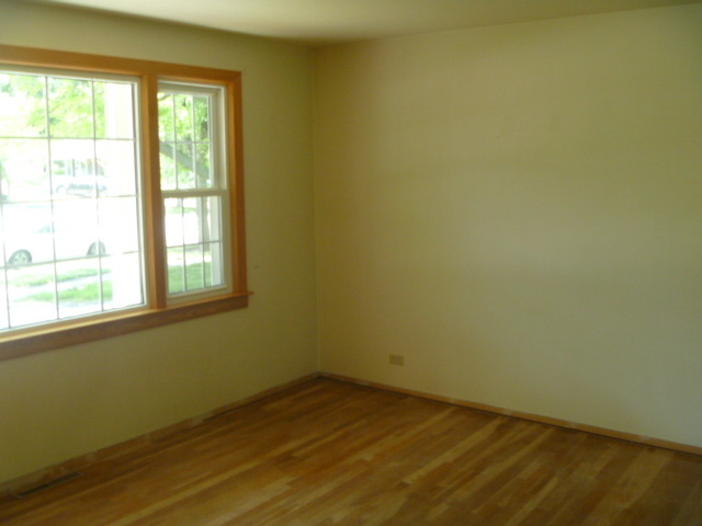 1513 North Ridge Avenue Arlington Heights, IL 60004 - Photo 2 of 14 a view of an empty room with wooden floor and a window
