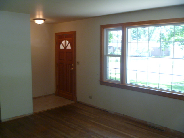 1513 North Ridge Avenue Arlington Heights, IL 60004 - Photo 3 of 14 an empty room with wooden floor and windows