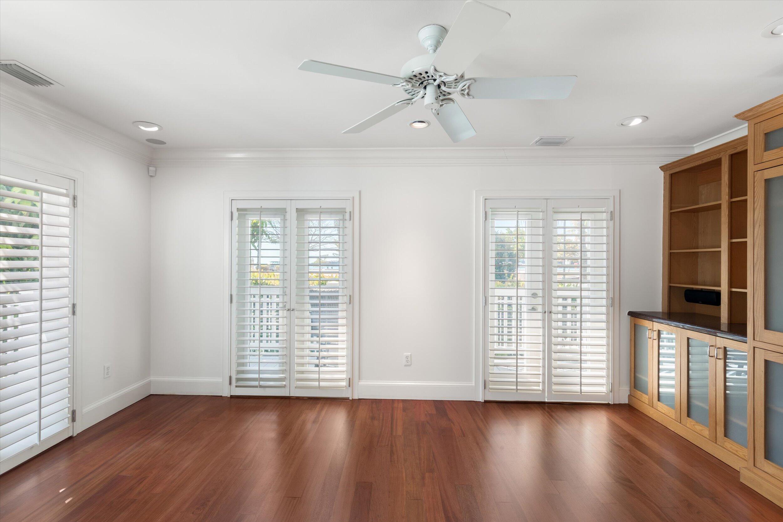 413 Emma Street, Unit A Key West, FL 33040 - Photo 11 of 64 wooden floor in an empty room with a window
