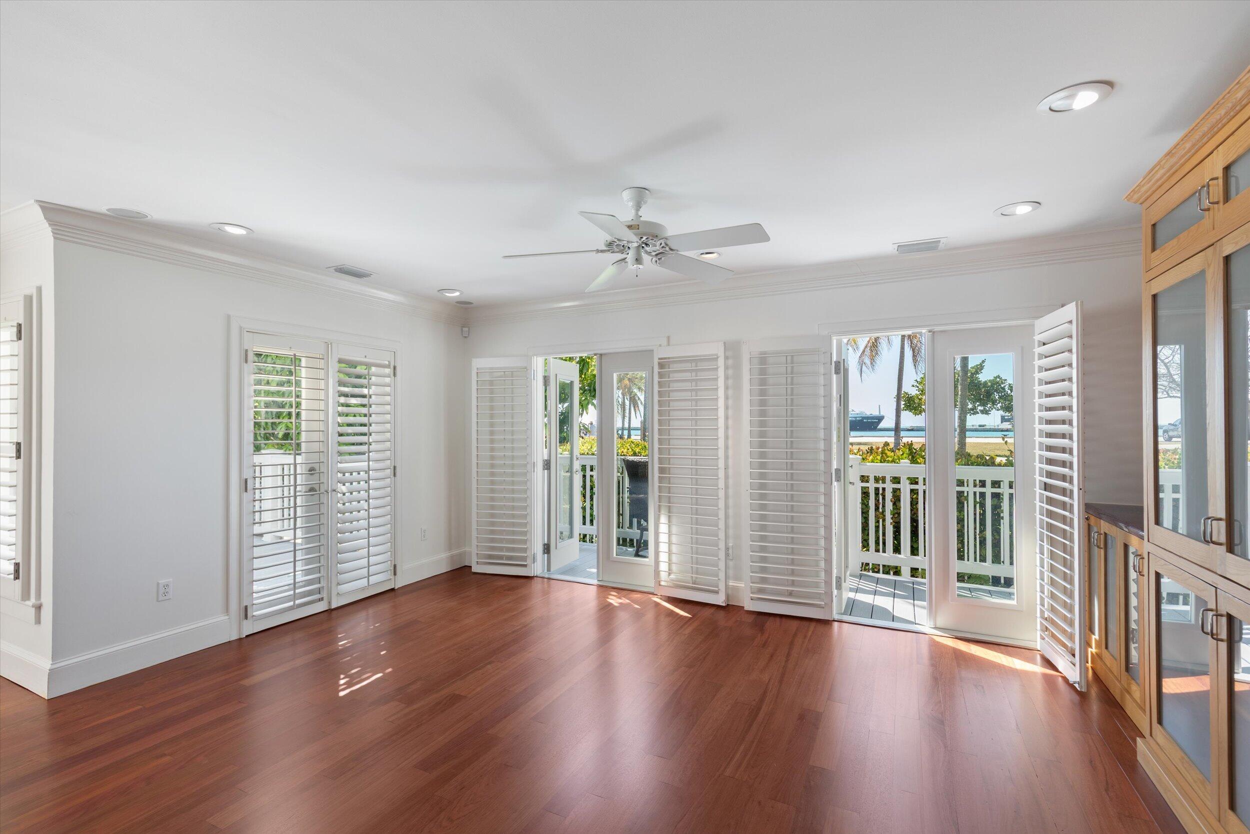 413 Emma Street, Unit A Key West, FL 33040 - Photo 12 of 64 wooden floor in an empty room with a window
