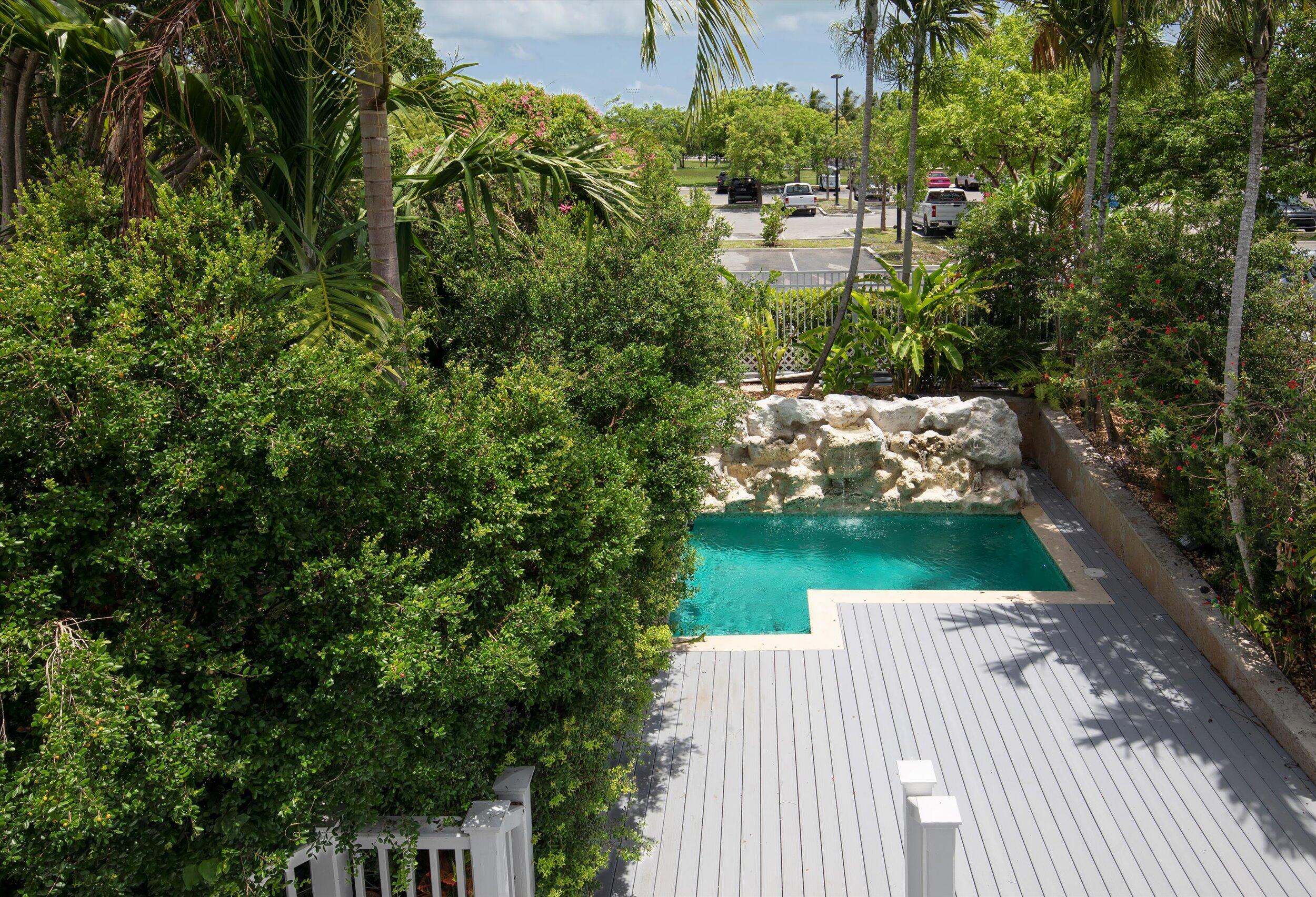 413 Emma Street, Unit A Key West, FL 33040 - Photo 18 of 64 a view of a wooden deck and a yard