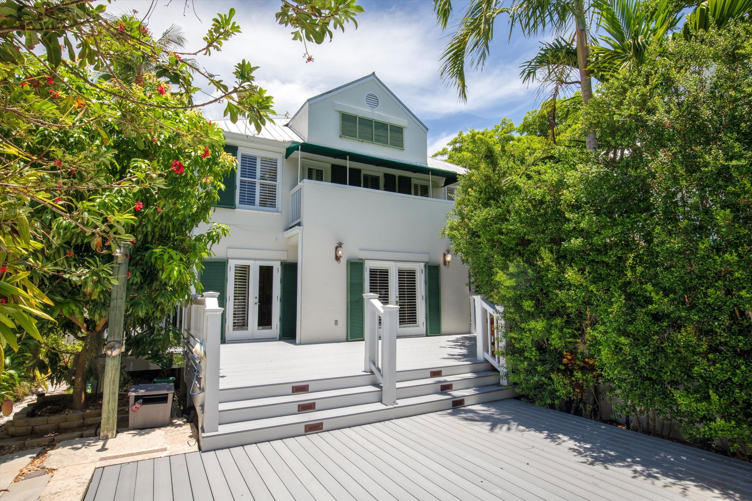 413 Emma Street, Unit A Key West, FL 33040 - Photo 19 of 64 front view of a house with a tree