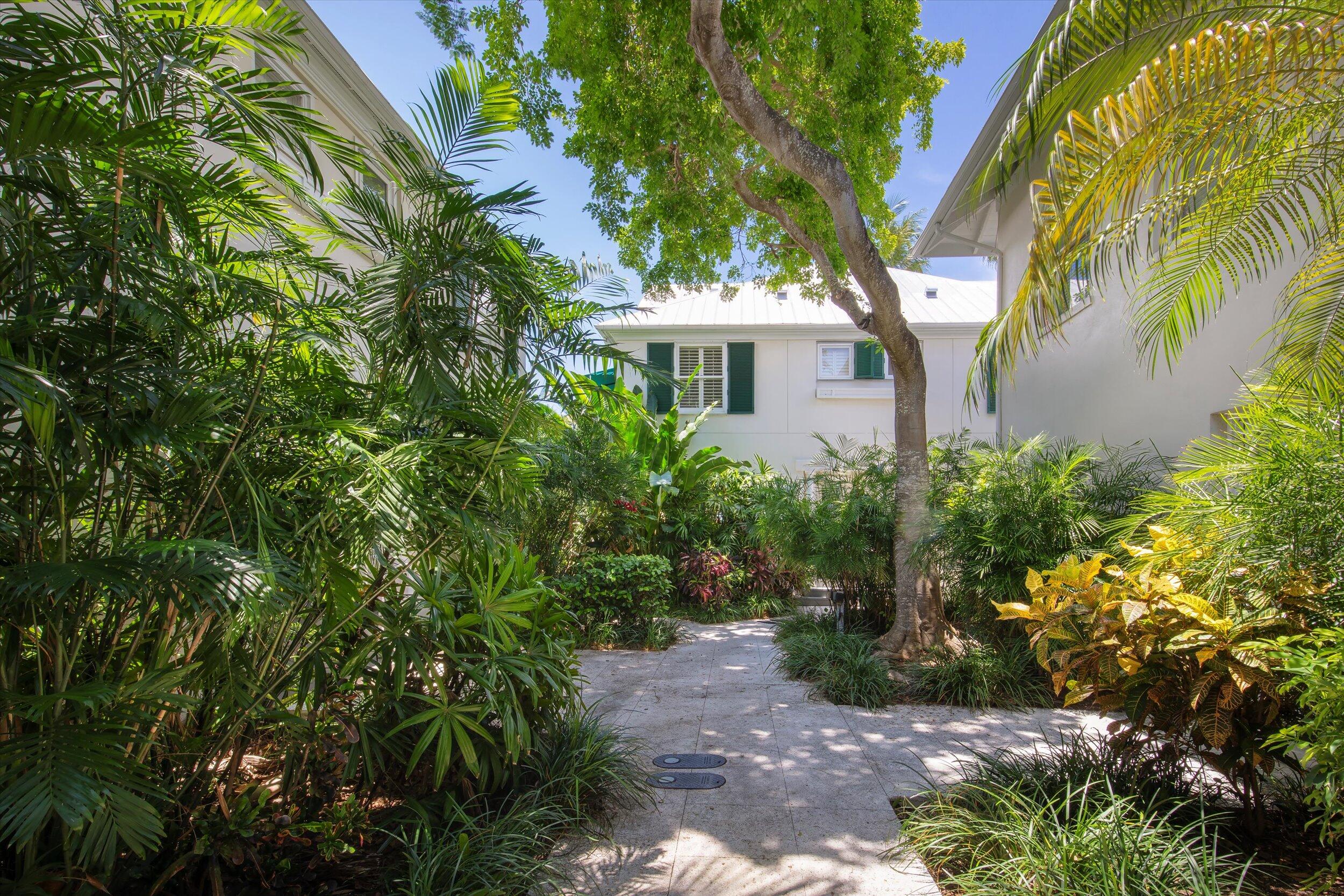 413 Emma Street, Unit A Key West, FL 33040 - Photo 2 of 64 a front view of a house with a garden